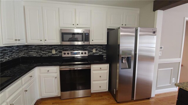 2477 Briar Valley Way, Dacula, GA 30019 - kitchen with white cabinetry, backsplash, and stainless steel appliances