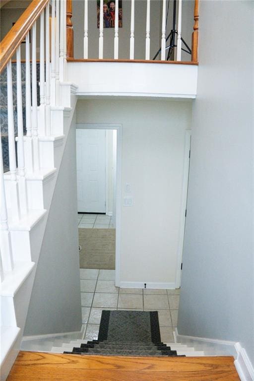 stairway with tile patterned floors