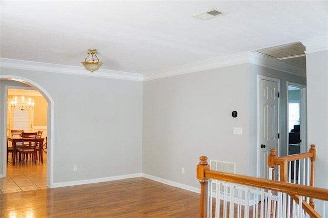 empty room with wood-type flooring and ornamental molding