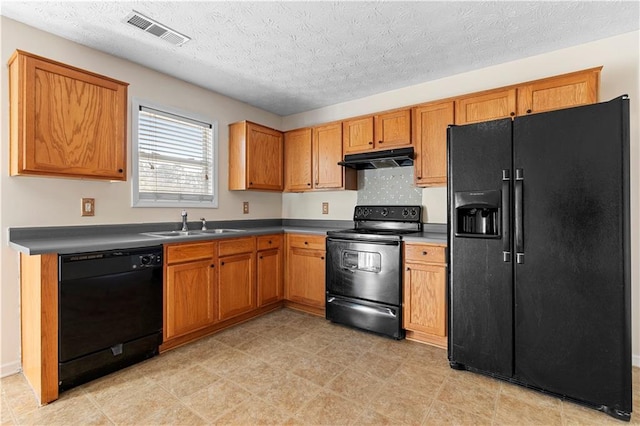 kitchen featuring sink, a textured ceiling, and black appliances