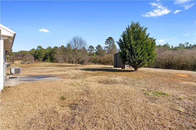 view of yard featuring central AC unit and a rural view