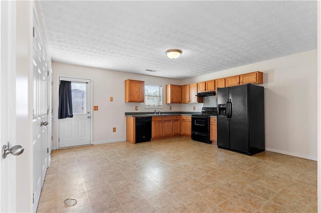 kitchen with black appliances, a textured ceiling, and sink