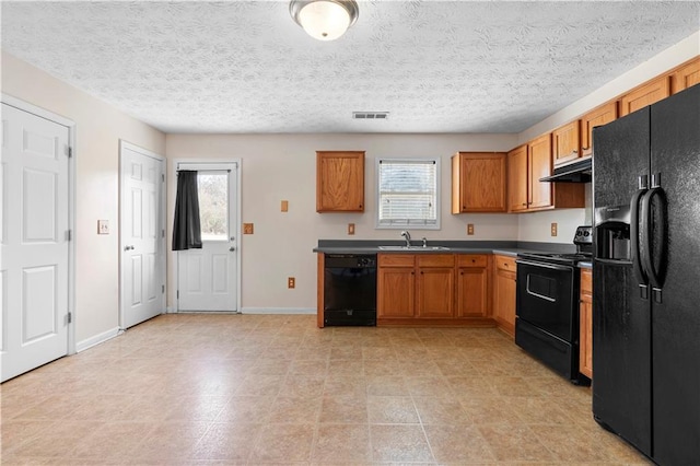 kitchen with sink, black appliances, and a textured ceiling