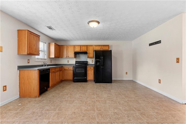 kitchen featuring black appliances, backsplash, a textured ceiling, and sink