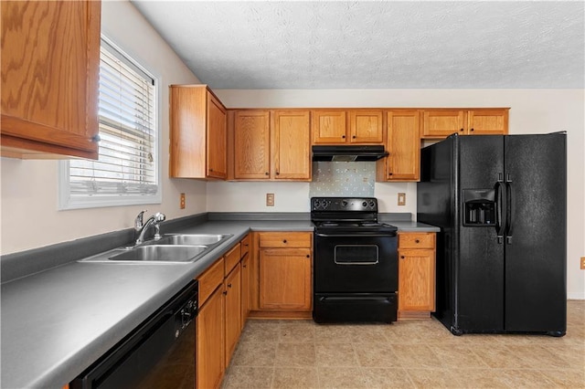 kitchen featuring black appliances, a textured ceiling, and sink