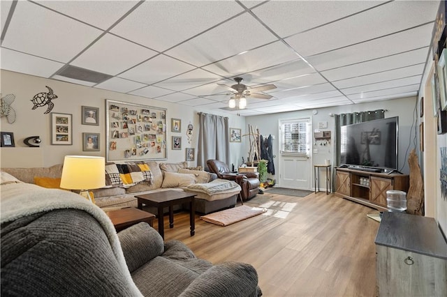 living area with a paneled ceiling, ceiling fan, and light wood-style flooring