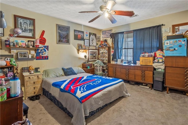 carpeted bedroom featuring a textured ceiling, ceiling fan, and visible vents