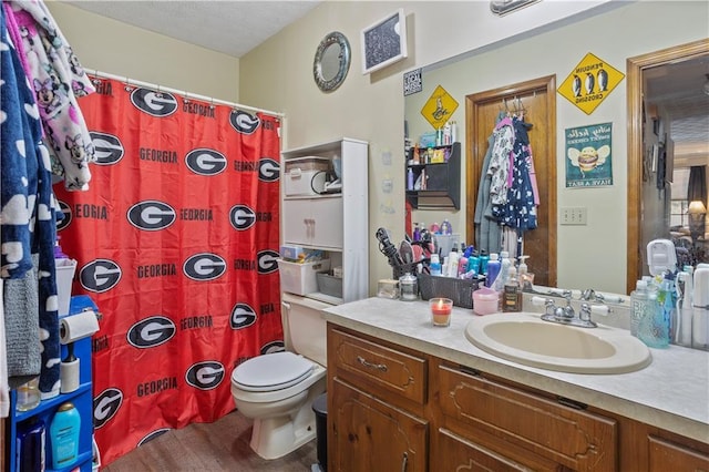 bathroom with a shower with curtain, vanity, and toilet