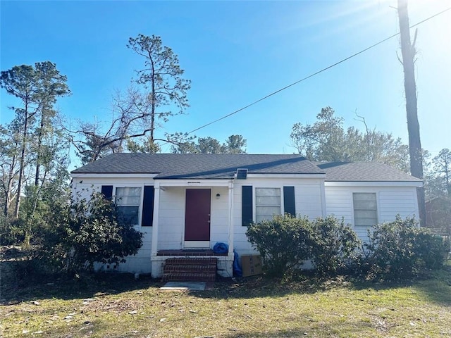 view of front facade with a front yard and entry steps