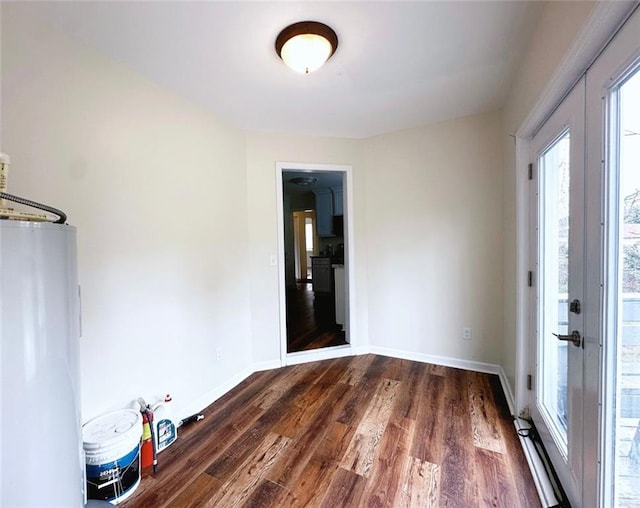 unfurnished room with french doors, baseboards, and dark wood finished floors