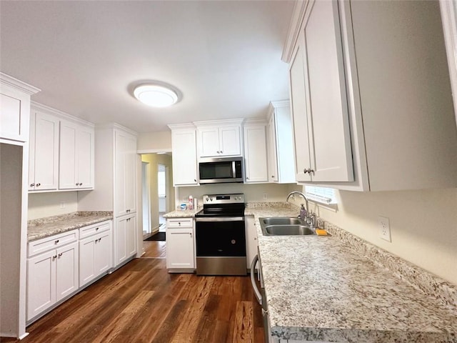 kitchen featuring a sink, dark wood-type flooring, appliances with stainless steel finishes, and white cabinets