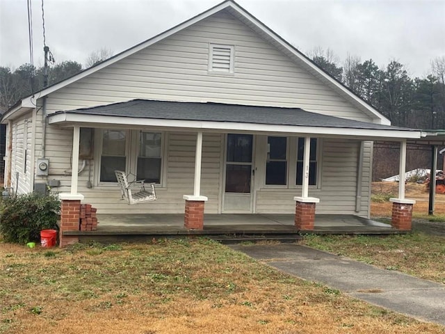 bungalow with a porch and a front yard