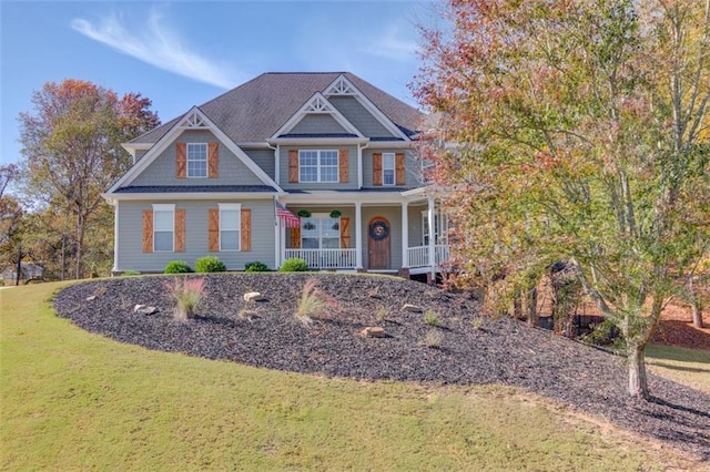 craftsman inspired home with a porch and a front lawn