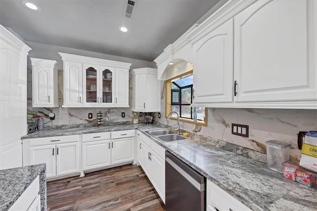 kitchen featuring decorative backsplash, white cabinets, stainless steel dishwasher, dark wood-type flooring, and sink