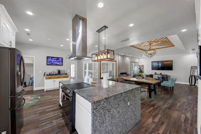 kitchen with island exhaust hood, black electric range oven, a center island, white cabinetry, and stainless steel fridge with ice dispenser