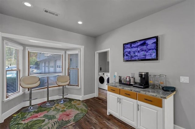 interior space featuring dark wood-type flooring and separate washer and dryer