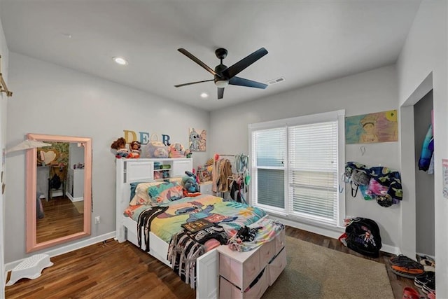 bedroom with dark wood-type flooring and ceiling fan