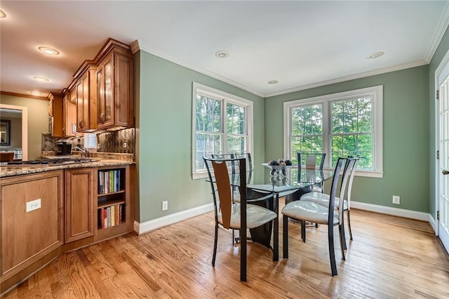 dining room with a healthy amount of sunlight, light wood finished floors, and baseboards