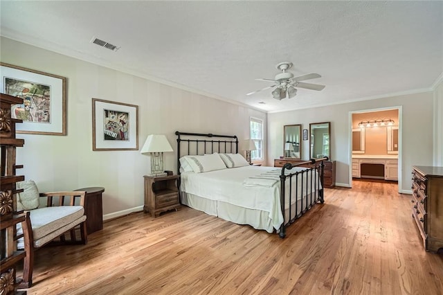 bedroom featuring ceiling fan, light wood finished floors, baseboards, visible vents, and crown molding