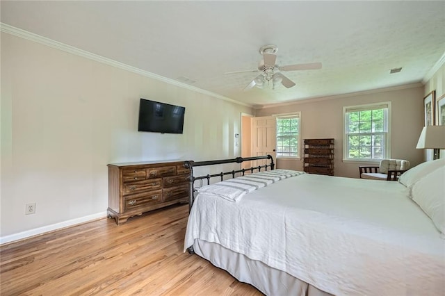 bedroom with ceiling fan, light wood-type flooring, ornamental molding, and baseboards
