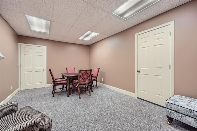 carpeted dining room with baseboards and a paneled ceiling