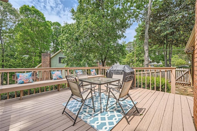 wooden terrace with outdoor dining space