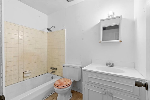 full bathroom featuring tiled shower / bath, vanity, and toilet