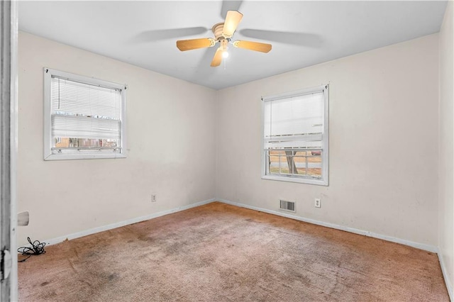 empty room with light colored carpet and ceiling fan