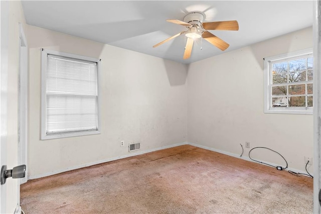 carpeted spare room with ceiling fan