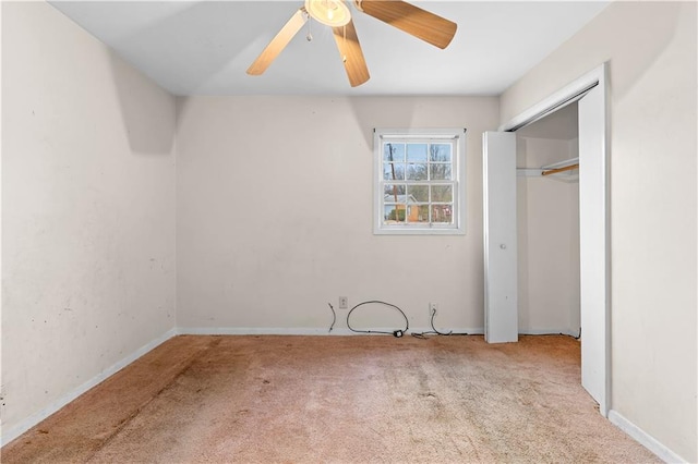 unfurnished bedroom with ceiling fan, light colored carpet, and a closet