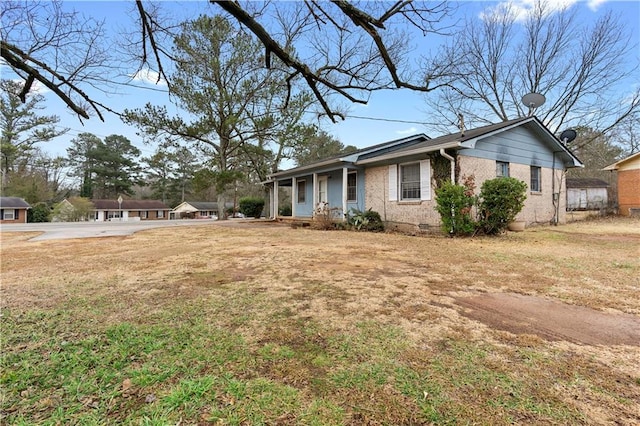 view of property exterior featuring a yard and a porch