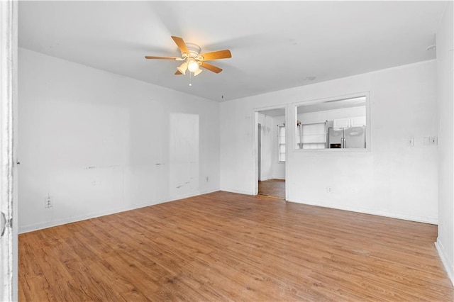 unfurnished living room with ceiling fan and light wood-type flooring