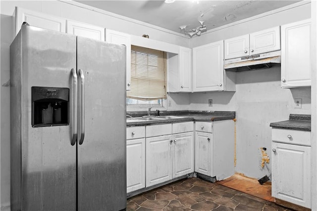 kitchen with white cabinetry, stainless steel fridge, and sink