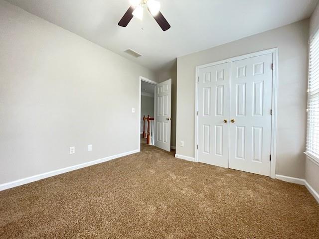 690 Kimball Parc Way, Alpharetta, GA 30022 - unfurnished bedroom with carpet floors, baseboards, a closet, and a ceiling fan