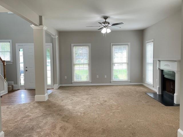 690 Kimball Parc Way, Alpharetta, GA 30022 - unfurnished living room featuring carpet, a ceiling fan, stairway, baseboards, and a fireplace with flush hearth