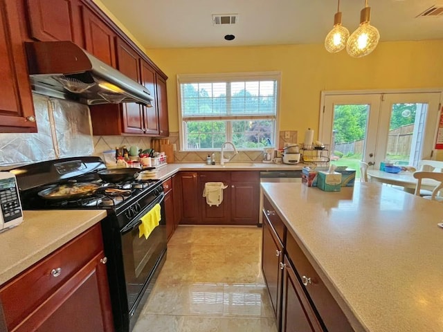 kitchen with under cabinet range hood, black gas stove, a sink, and light countertops