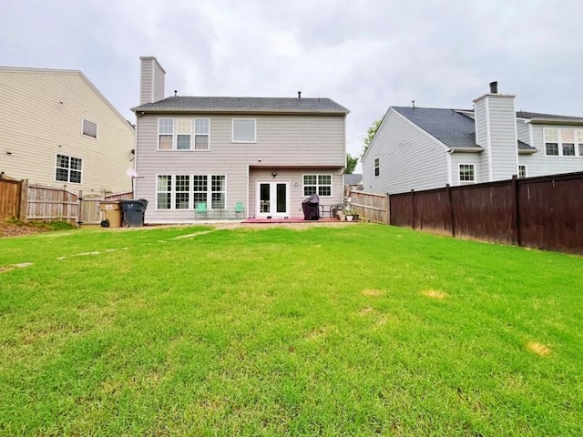 back of house featuring a patio area, french doors, and a chimney