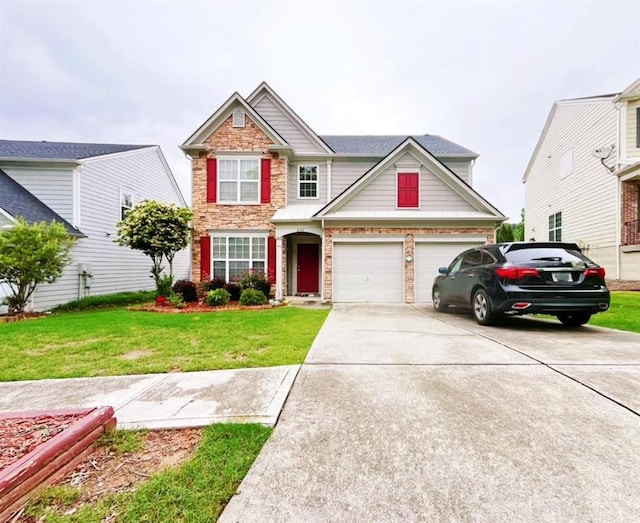 view of front of house with driveway, stone siding, a front yard, and a garage