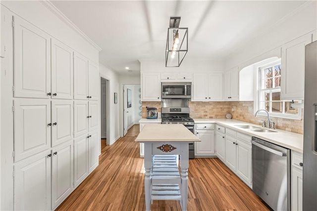 kitchen featuring a sink, white cabinetry, decorative backsplash, and appliances with stainless steel finishes