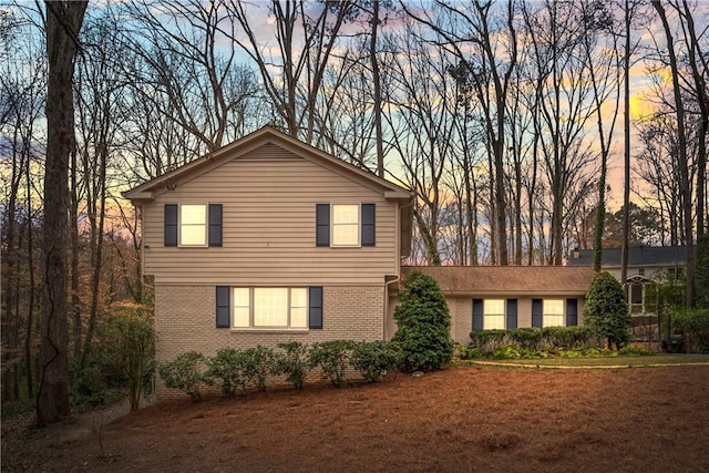 traditional-style house with brick siding