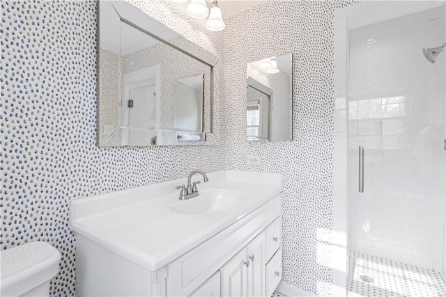 bathroom featuring tile walls, toilet, a stall shower, and vanity