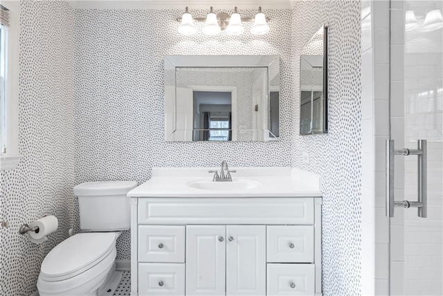 bathroom with tile walls, a shower with shower door, toilet, and vanity
