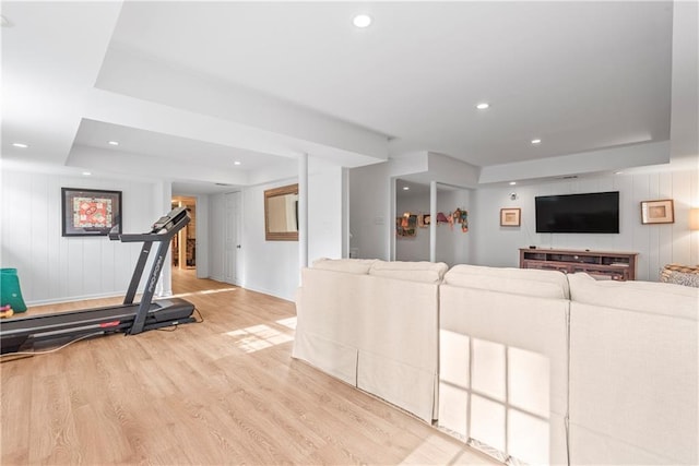 living room with wood finished floors, recessed lighting, and a raised ceiling