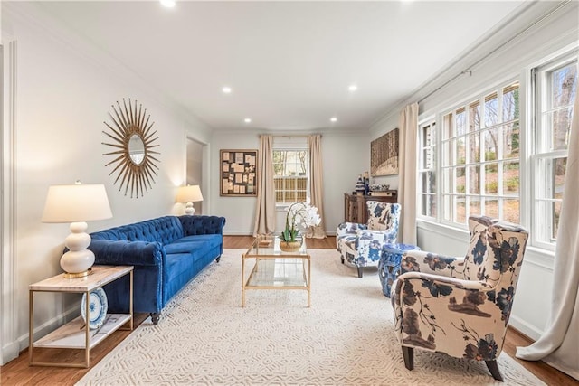 living area with baseboards, crown molding, wood finished floors, and recessed lighting