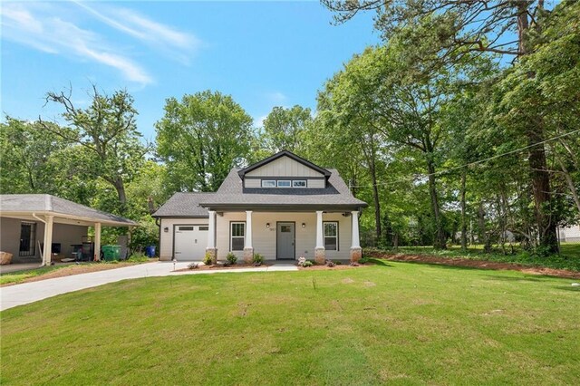 1857 Derrill Dr, Decatur, GA 30032 - view of front of home with driveway, an attached garage, covered porch, and a front yard