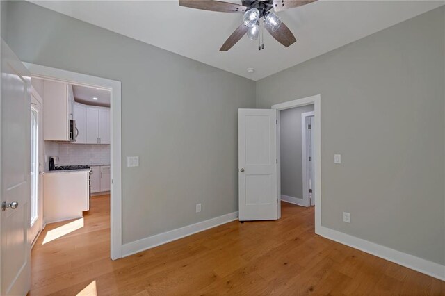 1857 Derrill Dr, Decatur, GA 30032 - unfurnished bedroom featuring baseboards, light wood-style floors, and ceiling fan