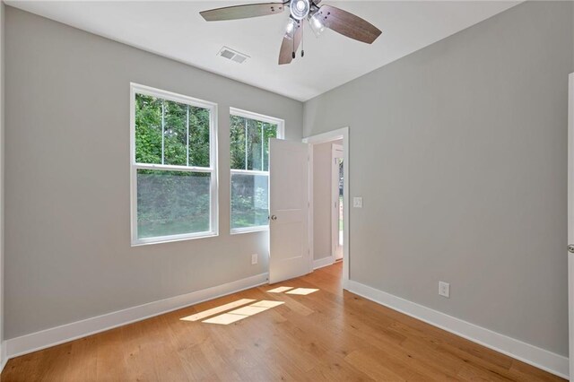 1857 Derrill Dr, Decatur, GA 30032 - unfurnished room featuring baseboards, visible vents, light wood-style floors, and a ceiling fan