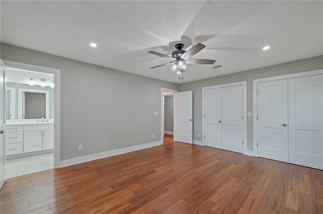 1857 Derrill Dr, Decatur, GA 30032 - unfurnished bedroom featuring two closets, visible vents, baseboards, and wood finished floors