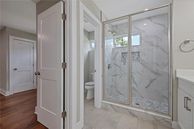 1857 Derrill Dr, Decatur, GA 30032 - bathroom featuring a marble finish shower, toilet, vanity, and wood finished floors