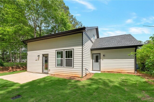 1857 Derrill Dr, Decatur, GA 30032 - back of property with roof with shingles, a yard, and a patio